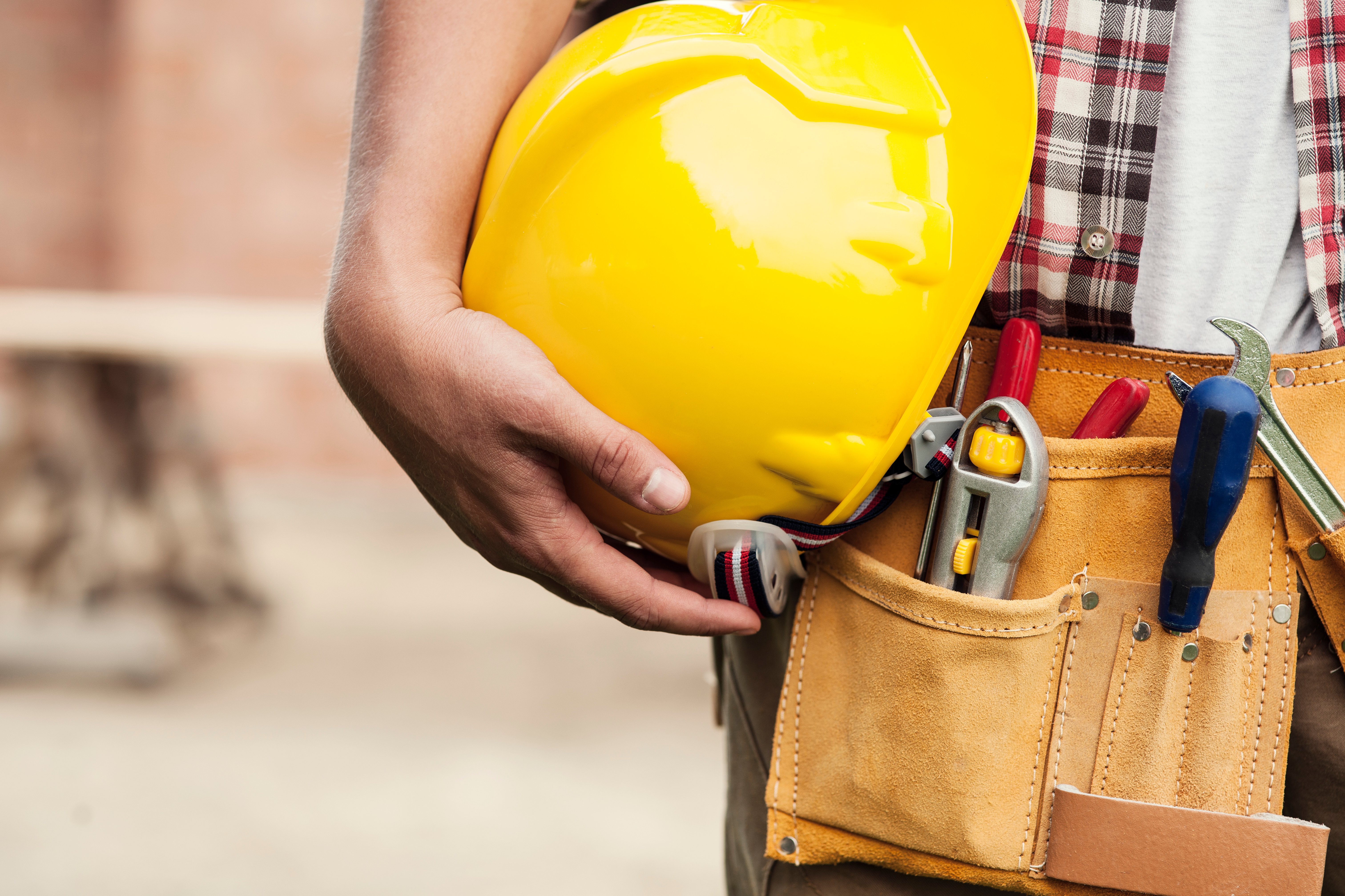 close-up-of-hard-hat-holding-by-construction-worker